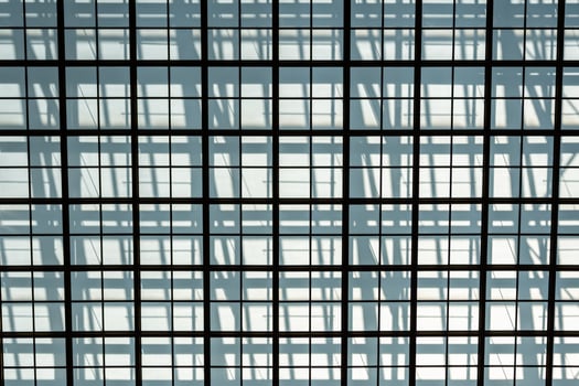 Metal grille against a gray wall, the shadow of the grille photo
