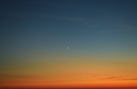 Crescent moon during sunset photo