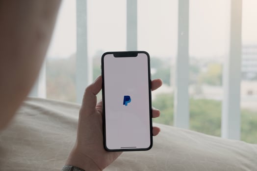 Chiang Mai, Thailand, Mar, 21, 2021 - Person using Paypal at home photo