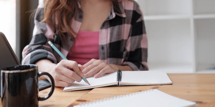 Woman writing in a notebook photo