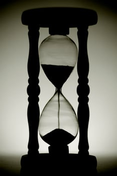 Backlit hourglass in black and white photo