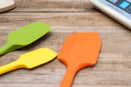 Silicone bakery and cooking tools on a wooden table photo