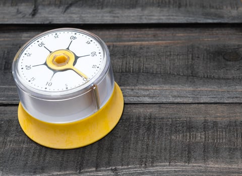 Bakery and cooking tools with a kitchen timer on a wooden table photo