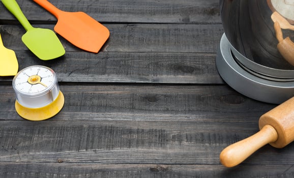 Bakery and cooking tools with a kitchen timer on a wooden table photo