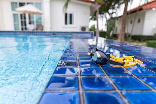 Goggles on the side of a swimming pool photo