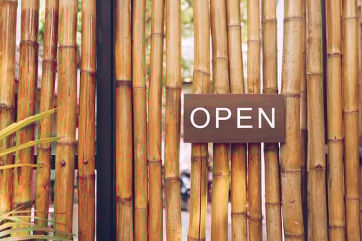 A business sign that says Open hanging on a door entrance. Vintage color tone style. photo