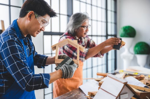 Two carpenters making a birdhouse photo