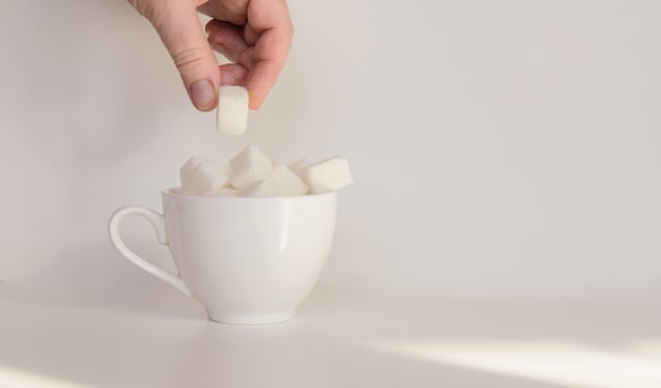 A coffee cup filled with lump sugar photo