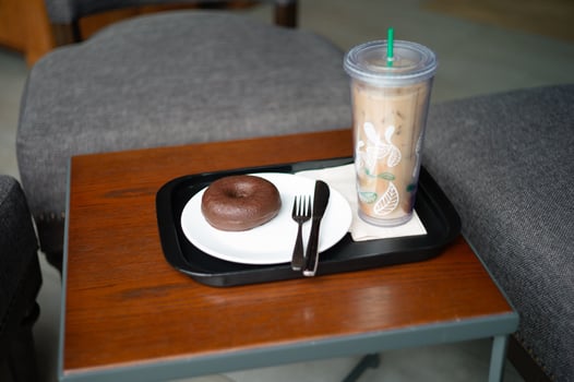 Chocolate doughnut served with a personnel glass of coffee photo