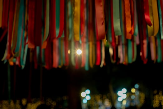 Abstract defocused colorful ribbons hanging from the roof for decoration in the celebration event photo