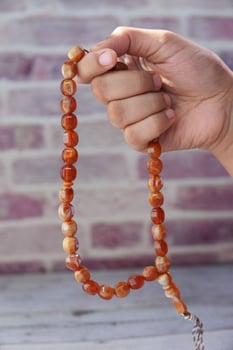 Person holding prayer beads photo