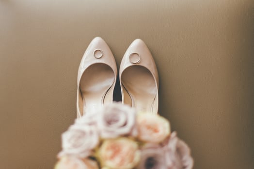 Floral bouquet with wedding shoes and rings photo
