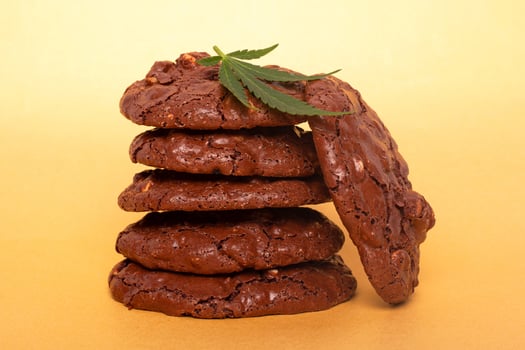 Cannabis cookies and green leaf on a yellow background photo