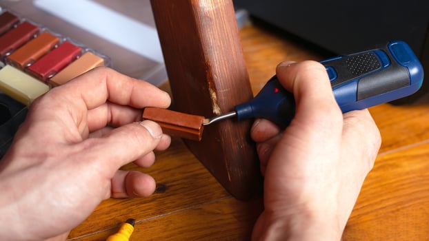 Restoration repair of wood surface on furniture photo