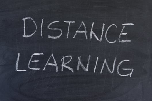 Hand-drawn title Distance Learning on black chalkboard. photo