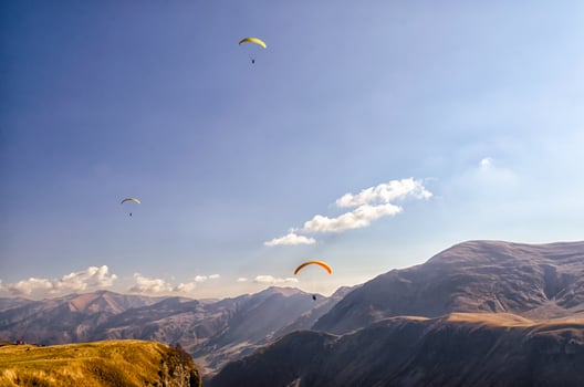 Three paragliders in the sky photo