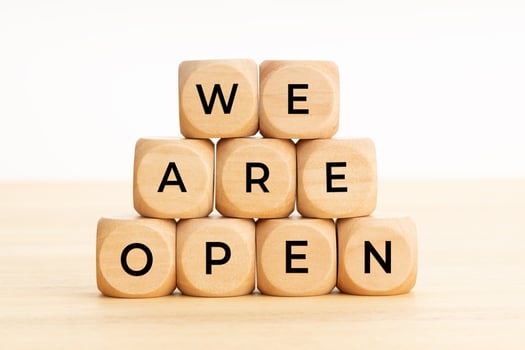 We Are Open words on wooden blocks on table photo