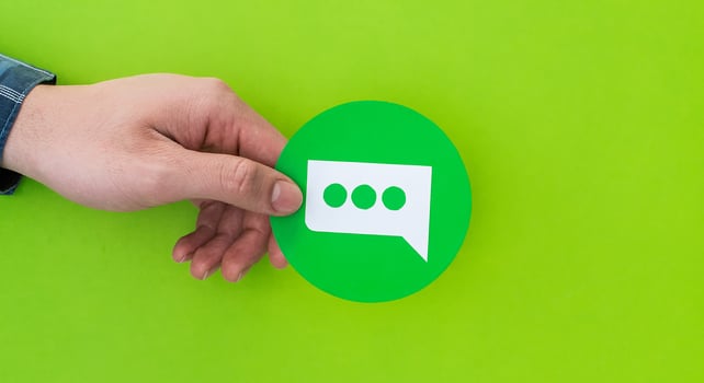 Male hand holding speech balloon shaped card photo