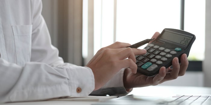 Close-up of a professional using a calculator photo