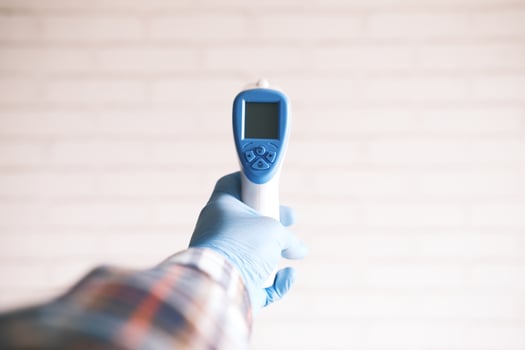 Hand holding infrared thermometer photo