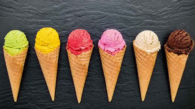 Various of ice cream flavor in cones on dark stone background photo