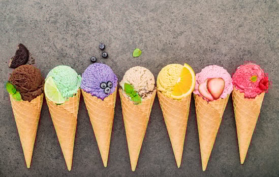 Flat lay ice cream cones collection on dark stone background photo