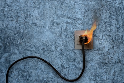 Electrical fire on wall plug photo