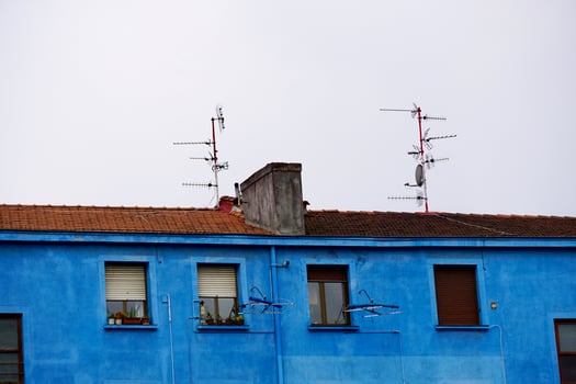 Television antenna on the rooftop of the house photo