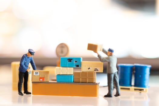 Miniature people, postman officers on duty preparing to send a box to the consumer. Delivery service for e-commerce concept photo