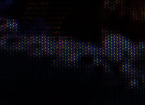 Abstract background pattern of colored blurry dots on a dark background close up photo
