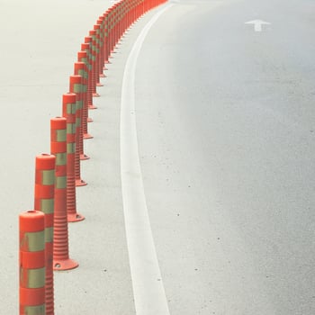 Red safety control plastic poles on the road. photo