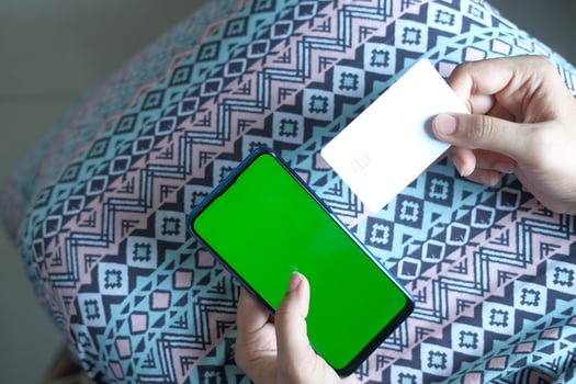 Woman holding a phone and business card mock-up photo