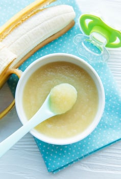 Bowl with fruit baby food and banana photo