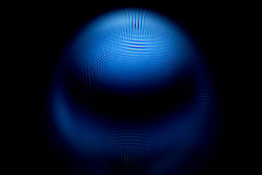 An abstract sphere with a blurry pattern isolated on black background. photo