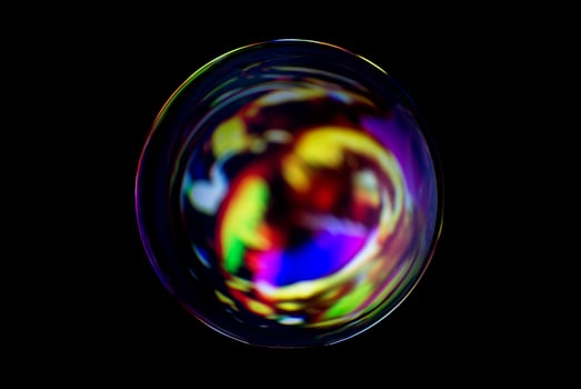 An abstract sphere with a blurry pattern isolated on black background. photo