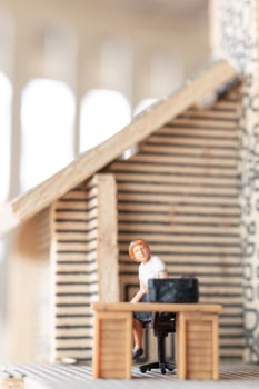 Miniature businesspeople working at home to protect themselves from coronavirus, work from home concept photo