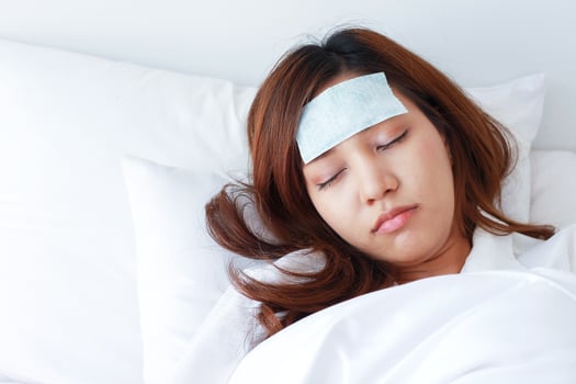 Young Asian woman is sick and sleeping in bed. photo