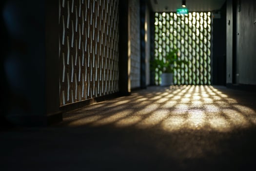 Selective focus on the cement floor of corridor reflecting light of sunset with blurred bokeh lights background. photo