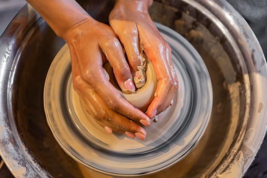 Hands shaping pottery photo