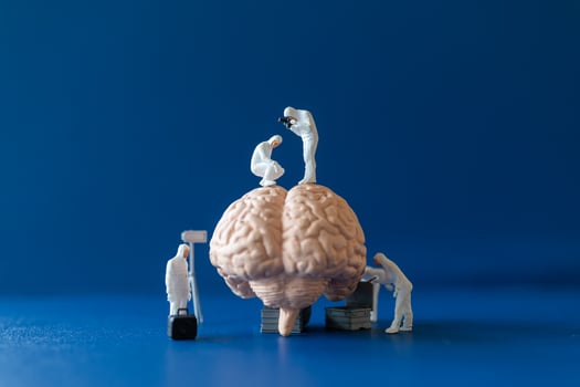 Miniature people, scientists observing and discussing the human brain, medical healthcare and surgical doctor service concept. photo