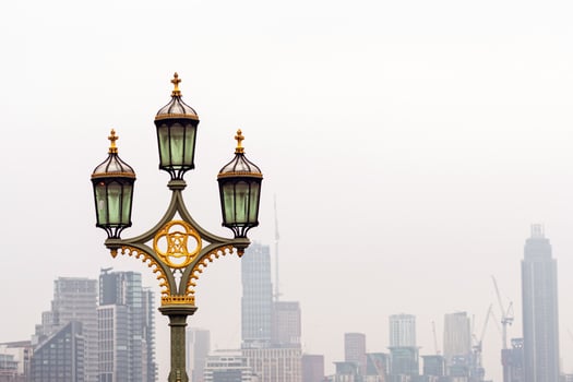Street lamps on Westminster Bridge, bloored skyscrapers on background, London, UK photo