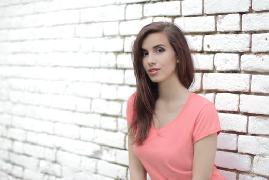 Woman on a white brick wall photo