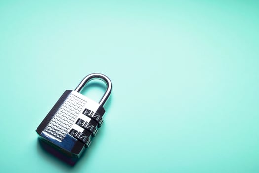 A shiny coded padlock on a bright turquoise background photo