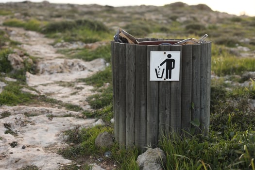 Wooden trash or litter bin in coastal areas near the sea photo