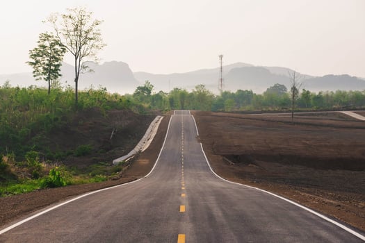 A long straight road leading towards a mountain photo