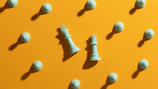 White chess pieces on yellow background photo
