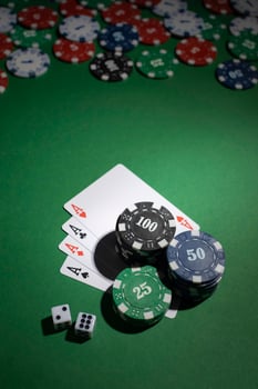 Casino tokens on green background with ace cards photo