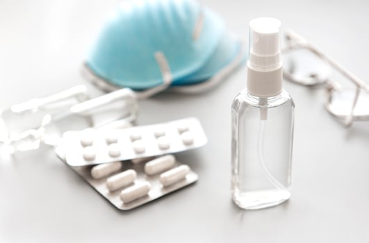 Antiseptic spray and blue medical mask photo