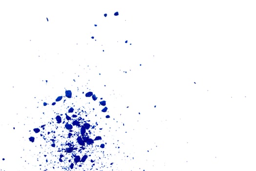 Fresh vivid blue color powder granular material spot on white background photo