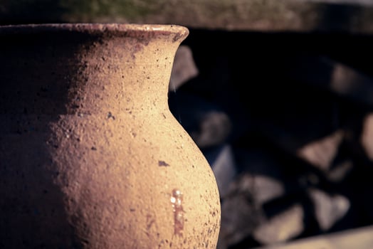 Ancient clay jug close-up outdoors on a sunny day photo
